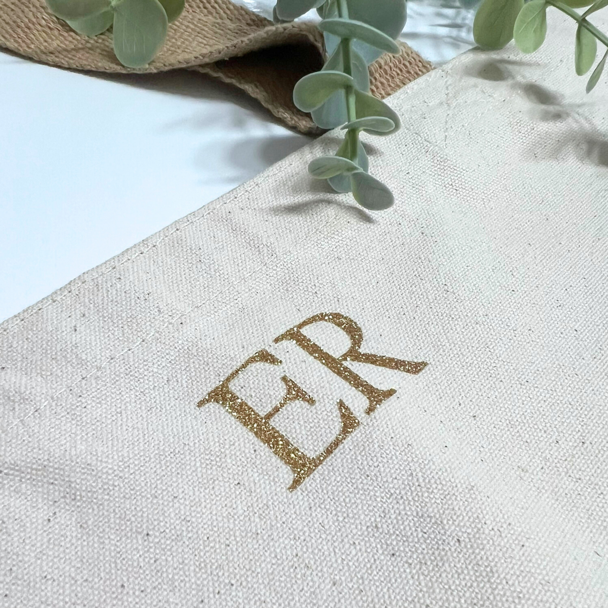 CLOSE UP OF GOLD GLITTER INITIALS