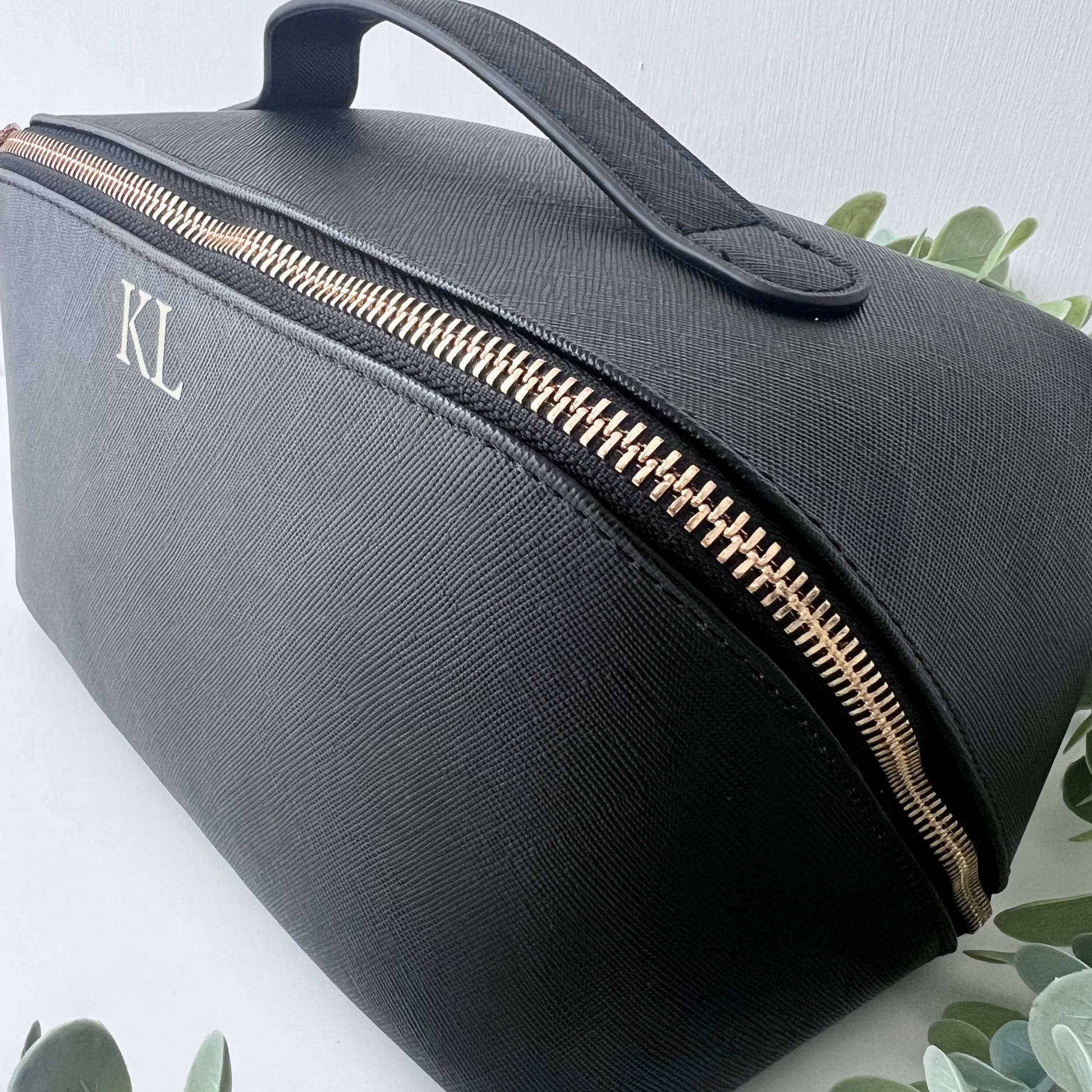 SIDE VIEW OF BLACK LUXURY INTIAL MAKE UP BAG